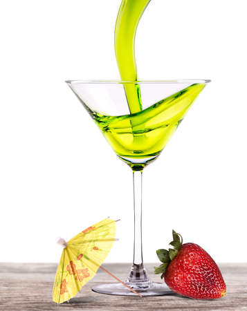 Set of alcoholic cocktail on a vintage wooden table with tasty strawberry and umbrellaの写真素材