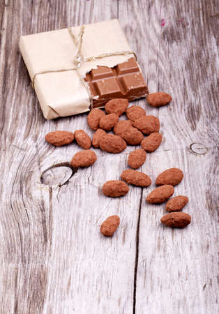 Cocoa nuts on a wooden table and Chocolate backgroundの写真素材