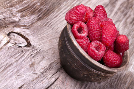 A beautiful selection of freshly picked ripe red raspberries.の写真素材