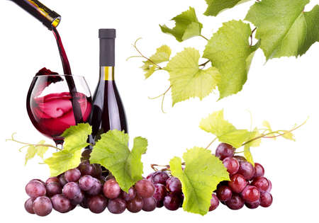 Ripe grapes, wine glass and bottle of wine isolated on white