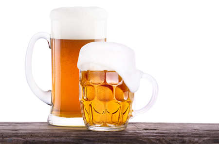 Beer glass on old wooden table background isolatedの写真素材