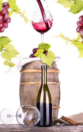 grapes on a wooden vintage barrel with corkscrew and wine glass isolated on a white backgroundの写真素材