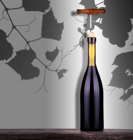 red wine and a bottle on a vintage wooden table