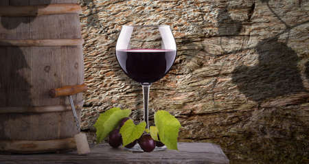grapes, corkscrew and wine glass on a wooden vintage barrel against grunge backgroundの写真素材