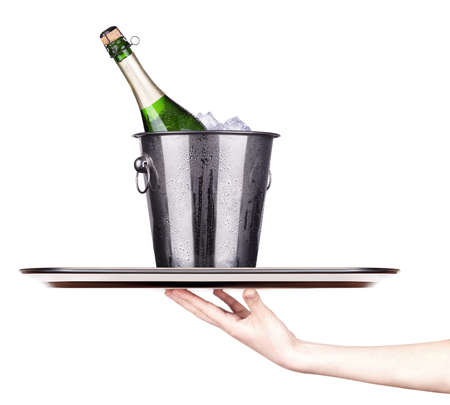 bottle of champagne in ice bucket on a trayの写真素材
