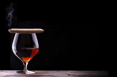 Cognac and Cigar on black with vintage tableの写真素材