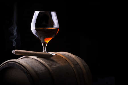 Cognac and Cigar on black with vintage barrelの写真素材