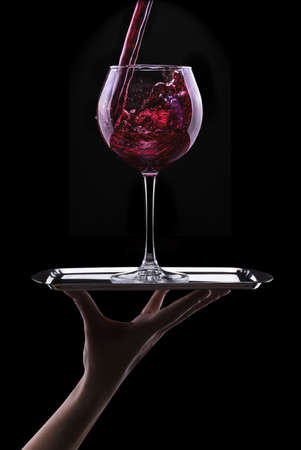 Elegant red wine glass in black backgroundの写真素材