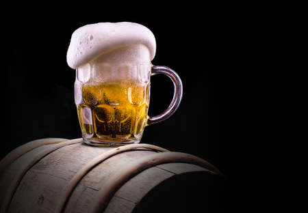 Frosty glass of light beer on black backgroundの写真素材