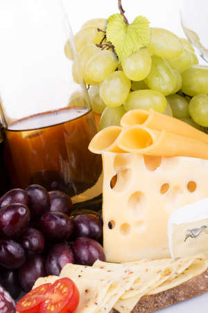 grapes and cheese on a wooden board macroの写真素材