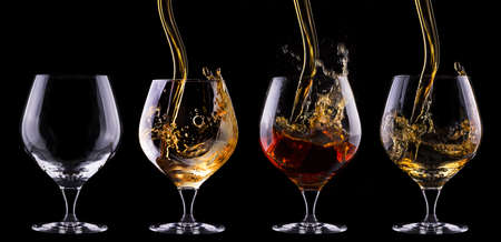 Cognac or brandy full and empty glass  set on a  black backgroundの写真素材