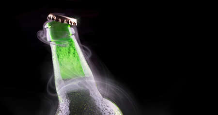 open wet beer bottle isolated on blackの写真素材