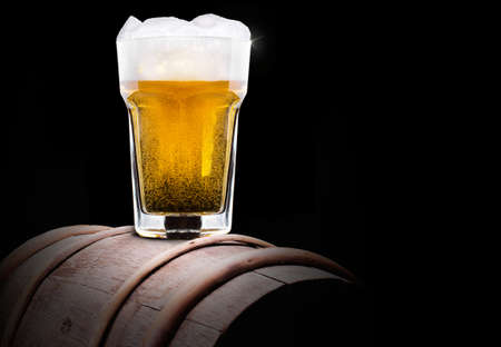 Frosty glass of light beer set isolated on a black の写真素材