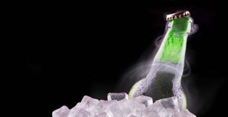 Cold beer bottle with chill smoke on black の写真素材