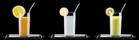 set of tasty summer fruits with juice in glass and tubeの写真素材