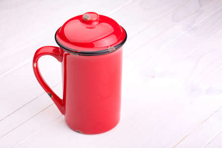 bright cup of Coffee on a white wooden vintage table. Grunge backgroundの写真素材