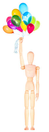 wooden Dummy holding flying balloons Isolated Over White Backgroundの写真素材