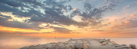 Barceloneta Beach in Barcelona with colorful sky at sunriseの写真素材