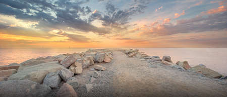 Barceloneta Beach in Barcelona with colorful sky at sunriseの写真素材