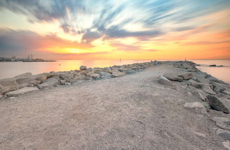 Barceloneta Beach in Barcelona with colorful sky at sunriseの写真素材