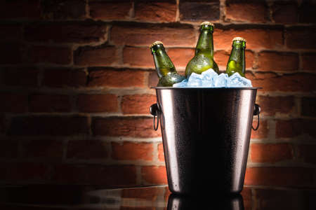 Beer bottles in ice bucketの写真素材