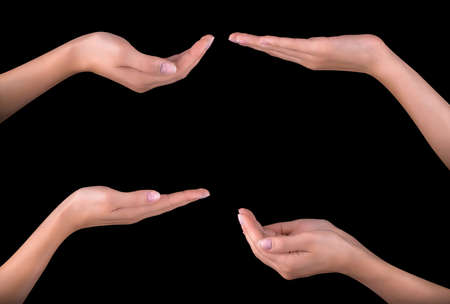 Beautiful woman hand holding isolated on black backgroundの写真素材