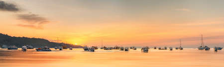 Beautiful image of sunset with colorful sky and Longtail boat on the sea tropical beach. Thailandの写真素材