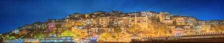 Istanbul skyline from Galata bridge by night, with Suleymaniye mosque and fish boat ferryの写真素材