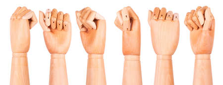 Closeup of right wooden hand - clenched fist, isolated over white background