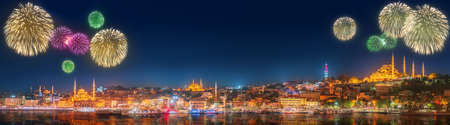 Cityscape with Galata Tower, Golden Horn and ferry wirh beautiful fireworks in Istanbul, Turkeyの写真素材