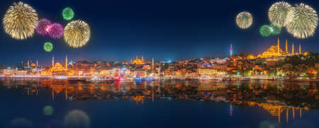 Cityscape with Galata Tower, Golden Horn and ferry wirh beautiful fireworks in Istanbul, Turkeyの写真素材