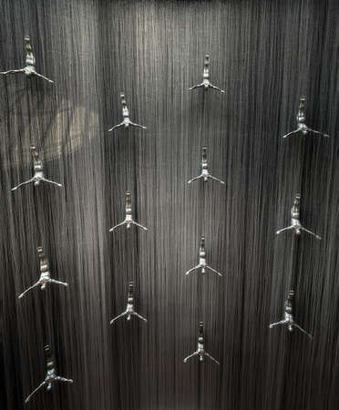 Famous Waterfall with art fiberglass sculptures of human divers in Dubai Mall, UAE.の写真素材
