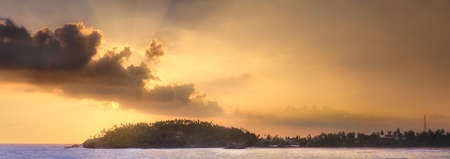 Tropical beach on sunsetの写真素材