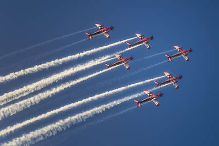 Reactive jet plane flying in formation on blue skyの写真素材