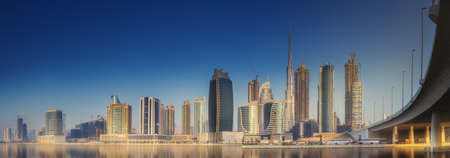 Cityscape of Dubai and panoramic view of Business bay with reflection of skyscrapers on water at day time, UAE.の写真素材