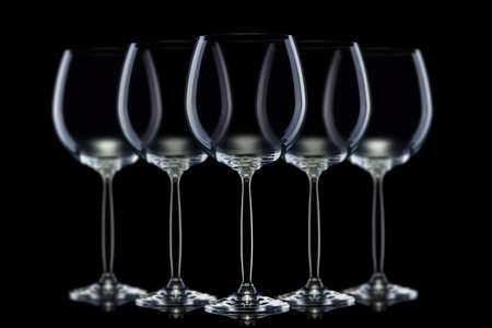 Set of empty glasses for red wine in a row isolated on black