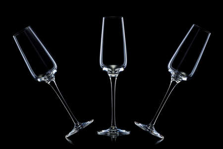 Set of empty luxury champagne glasses in a row isolated on a blackの写真素材