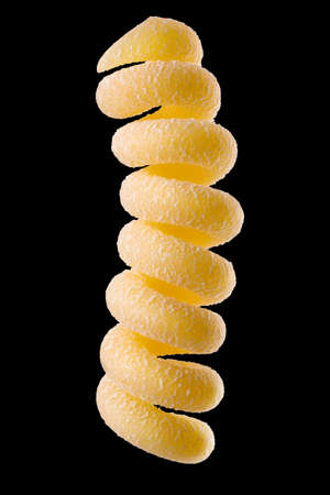 Yellow fusilli pasta isolated on black with clipping pathの写真素材