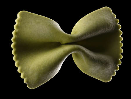 Macro photo of green farfalle pasta isolated on black with clipping path