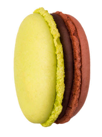 Macro photo of french caramel and pistachio macaroon isolated on whiteの写真素材