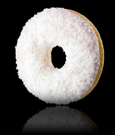 Chocolate glazed donut with sprinkles on a black background rotatedの写真素材