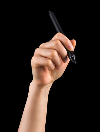 Hand holding digital graphic pen and drawing something isolated on blackの写真素材