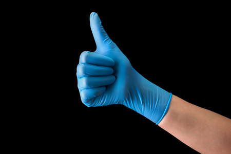 Doctors hand in medical gloves in gesture of like sign giving thumb up isolated