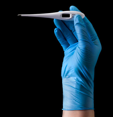 Doctors hand in medical gloves holding thermometer with two fingers isolated