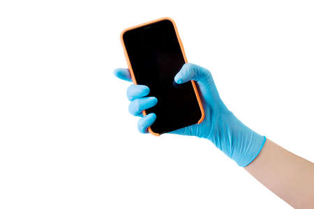 Doctors hand in medical gloves holding phone isolated on whiteの写真素材