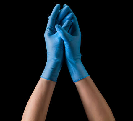 Doctors hand in sterile medical gloves together symbolizing prayer isolated