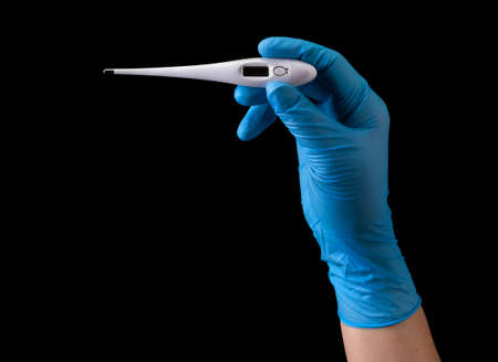 Doctors hand in medical gloves holding thermometer with two fingers isolated