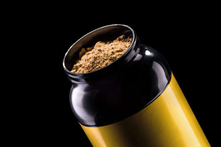 Sport nutrition like whey protein casein, bcaa, creatine plastic jar isolated on black background . Concept of fitness supplementの写真素材