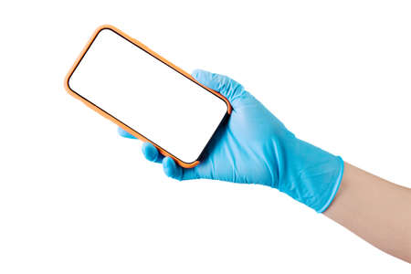 Doctor's hand in sterile medical gloves holding phone isolated on white backgroundの写真素材