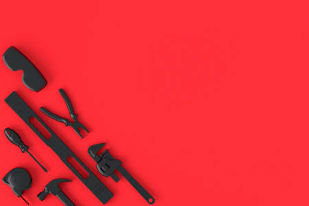 Top view of monochrome construction tools for repair on red and blackの写真素材